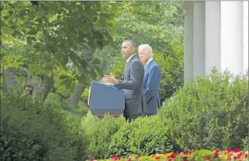  ?? Michael Reynolds EPA ?? PRESIDENT OBAMA, with Vice President Joe Biden at his side in the White House Rose Garden, talks about the Supreme Court’s decision upholding billions of dollars in Obamacare subsidies for U. S. consumers.