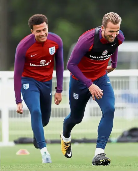  ??  ?? Light work: England’s Harry Kane (right) and Dele Alli warming up at a training session yesterday. England face Slovakia today. — Reuters