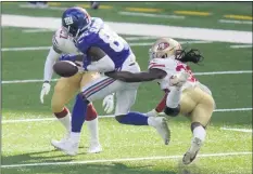  ?? COREY SIPKIN - THE ASSOCIATED PRESS ?? San Francisco 49ers’ Marcell Harris, right, punches the ball away from New York Giants’ Darius Slayton during the second half of an NFL football game, Sunday, Sept. 27, 2020, in East Rutherford, N.J.