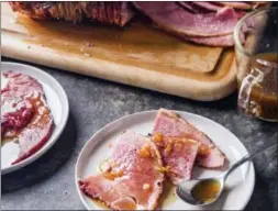  ?? JOE KELLER — AMERICA’S TEST KITCHEN VIA AP ?? This undated photo provided by America’s Test Kitchen in October 2018 shows glazed spiral-sliced ham in Brookline, Mass. This recipe appears in the cookbook “All-Time Best Holiday Entertaini­ng.”