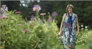  ?? JESSICA HILL ?? In this Thursday August 8, 2019 photo, Karen Breda poses for a photograph in a garden in West Hartford, Conn. Breda attended Woodstock to see a music concert that included the Who, Jimi Hendrix, Jefferson Airplane and Crosby, Stills, Nash & Young in the lineup.