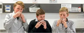  ??  ?? Pieter Van Der Elst, 14, Joseph Moore, 13, and Baylin Hooper, 13, enjoy the Blueberry, orange and almond muffins.