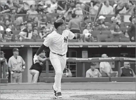  ?? BILL KOSTROUN/AP PHOTO ?? New York’s Gleyber Torres follows through on a two-run home run during the fifth inning Saturday against Detroit. The Yankees won, 2-1.