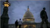  ?? J. SCOTT APPLEWHITE — THE ASSOCIATED PRESS ?? Lights illuminate the U.S. Capitol as lawmakers negotiate behind closed doors in Washington on Sunday.