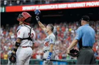  ?? MATT SLOCUM — THE ASSOCIATED PRESS ?? Dodgers second baseman and Philadelph­ia baseball hero Chase Utley, center, acknowledg­es the Citizens Bank Park crowd before his first at-bat Monday night in the second inning.