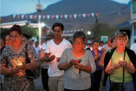  ??  ?? Vigil: Parents of missing children and Griselda Barradas (left) attending a service for her son Pedro Alberto Huesca, whose remains were found at one of the unmarked graves in Palmas de Abajo, Veracruz, Mexico. — Reuters