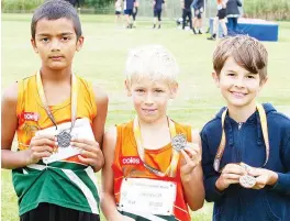  ?? ?? Right: Taking out the medals in the shot put are (from left) Ethan Fernando (third), Charlie Pratt (first) and Josh Finger (second).