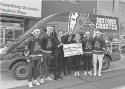  ?? JENNA ORTIZ/THE REPUBLIC ?? Coyotes players J.J. Moser, Nick Bjugstad, Liam O’Brien, and Juuso Valimaki present a check with Coyotes Foundation Chairwoman Alexis Meruelo to the Phoenix Children’s Hospital.