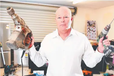  ??  ?? Mark Stringer shows off approximat­ely $160,000 worth of stolen goods recovered from a home in Howard Springs