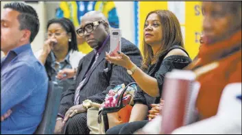  ??  ?? Attendees listen to candidates speak during a Ward 5 candidate forum.