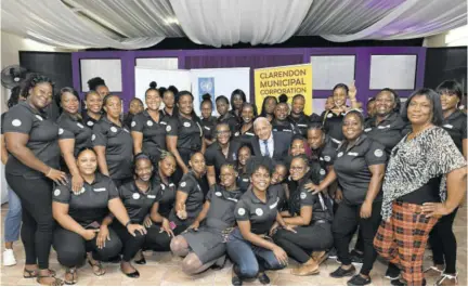  ?? ?? Survivors of domestic abuse share a photo with mayor of May Pen, Winston Maragh.