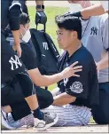  ?? ADAM HUNGER/AP ?? Yankees pitcher Masahiro Tanaka is tended to by team medical personnel after being hit by a Giancarlo Stanton line drive during a Saturday workout.