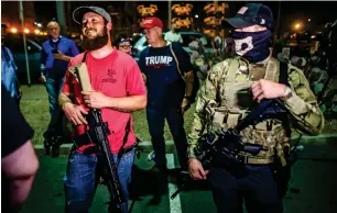  ?? AP ?? Armed supporters of President Donald Trump stand outside of Maricopa County Recorder’s Office where votes in the general election are being counted in Phoenix on Thursday. —