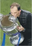  ??  ?? Chelsea manager Thomas Tuchel celebrates with the trophy.