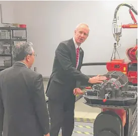  ?? ADAM THORP/FOR THE SUN-TIMES ?? Gov. Bruce Rauner and Japanese Ambassador to the United States Shinsuke J. Sugiyama tour a machine-parts facility in Schaumburg.