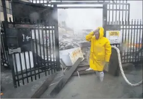  ?? ERIC GAY — THE ASSOCIATED PRESS ?? Jame Rowles examines the damage after the docks at the marina where his boat was secured were destroyed as Hurricane Hanna made landfall July 25 in Corpus Christi, Texas.