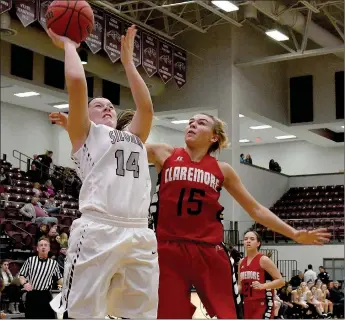  ?? Bud Sullins/Special to Siloam Sunday ?? Siloam Springs junior Morgan Vaughn takes the ball to the basket as Claremore (Okla.) senior Lauren Chancellor defends during Friday’s third-place game of the Siloam Springs Holiday Classic. Vaughn scored a career-high 37 points as the Lady Panthers...