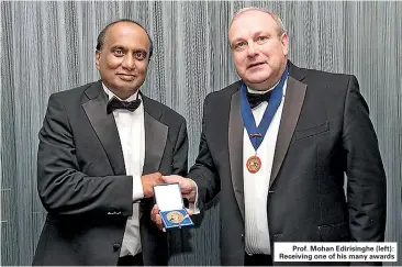  ??  ?? Prof. Mohan Edirisingh­e (left): Receiving one of his many awards