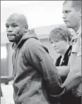  ?? By David Becker, Getty Images ?? Time to go: Boxer Floyd Mayweather Jr. is led to jail in Las Vegas on June 1.