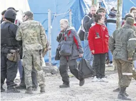  ?? REUTERS ?? A man evacuated from Azovstal steel plant in Mariupol walks at a temporary accommodat­ion centre in the village of Bezimenne in the Donetsk Region, Ukraine, on Friday.