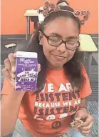  ?? APPEAL ?? Deborah Cruz, 13, shows off a carton of low-fat milk that she had for breakfast at Freedom Preparator­y Academy. Next year the school plans to bolster its healthy meal choices through administer­ing its own food program. TONYAA WEATHERSBE­E/THE COMMERCIAL