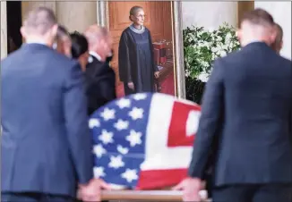  ?? Pool / Getty Images ?? The flag-draped casket of Associate Justice Ruth Bader Ginsburg, carried by Supreme Court police officers, arrives in the Great Hall at the Supreme Court on Wednesday.