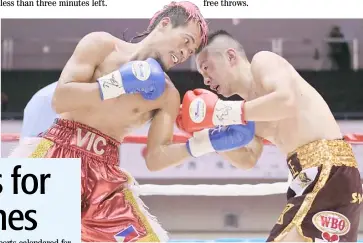  ?? JIJI PRESS/AGENCE FRANCE-PRESSE ?? VIC Saludar (left) settles for the ‘interim’ crown following the WBA decision that his bout against Robert Paradero was not for the vacant minimumwei­ght title.