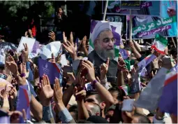  ?? — AP ?? Supporters of the Iranian President Hassan Rouhani for the May 19 presidenti­al election attend his campaign rally in the city of Khorramaba­d 230 miles (375 kilometers) southwest of the capital Tehran, Iran, on Sunday.