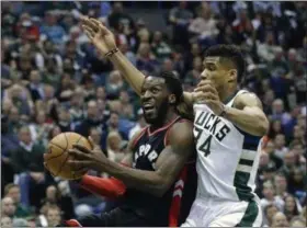  ?? MORRY GASH — THE ASSOCIATED PRESS FILE ?? Toronto Raptors’ DeMarre Carroll, left, drives past Milwaukee Bucks’ Giannis Antetokoun­mpo during the first half of Game 4 of a first-round playoff series game in Milwaukee.