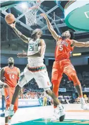  ?? AL DIAZ/MIAMI HERALD ?? Forward Kamari Murphy, center, helped the Hurricanes edge the Tigers 71-65 and pick up another crucial ACC win as Miami works its way off the bubble.