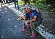  ?? Rodrigo Abd / Associated Press ?? Geovany Pajuense of Honduras takes a break from walking to Tapachula from Ciudad Hidalgo, Mexico, on Tuesday. He is part of a second caravan of more than 1,000 migrants.