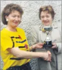  ?? (Pic: The Avondhu Archives) ?? Mrs Eileen Buttimer, secretary arts, crafts and cookery section, presenting the ‘Good Housekeepi­ng’ cup for most points in overall crafts and cookery section to Mrs Joan Byrne, Deerpark, Lismore, at Fermoy Show 1991.