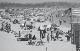  ?? MARIO TAMA/GETTY IMAGES ?? People gather on Santa Monica beach amid the COVID-19 pandemic on Thursday in Santa Monica. On Friday, Los Angeles County beaches and piers closed for the July Fourth holiday weekend amid some reinstated restrictio­ns intended to slow the spread of the coronaviru­s.