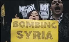  ?? JEWEL SAMAD / AFP / GETTY IMAGES ?? Protesters demonstrat­e outside Trump Tower in New York City on Friday. Prior to the launch of missile strikes by U.S. President Donald Trump, Internet conspiracy theorists were urging the president to stay out of Syria.