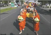  ?? (AP/Heng Sinith) ?? Buddhist monks lead a march and offer prayers Saturday during a Meak Bochea celebratio­n in Phnom Penh, Cambodia. The religious holiday is held in veneration of Buddha.