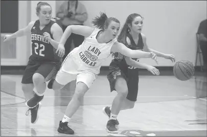  ?? The Sentinel-Record/Richard Rasmussen ?? COBRA SEAL: Fountain Lake’s Hannah Ross fights for a loose ball Tuesday against Lexi Bassett and Taryn Anderson of Jessievill­e. The Lady Cobras shot 21-for-36 on free throws to seal a 44-41 win.