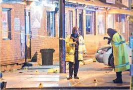  ?? PIC/PTI ?? New Orleans Police Department Investigat­ors work at the scene of a shooting in New Orleans