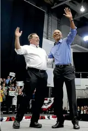  ?? AP ?? Former president Barack Obama, right, and Democrat candidate Senator Joe Donnelly wave to the crowd.