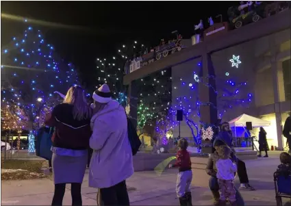  ?? PHOTOS BY DANA CADEY — STAFF WRITER ?? The lighting of trees around the Civic Center Plaza in downtown Longmont dazzles guests Friday night. The lighting, a holiday tradition, drew around 500 people this year.