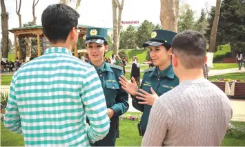  ??  ?? Fatima and Zukhra speaking with men in the famed silk road city of Samarkand.