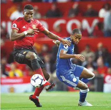  ?? AFP ?? United’s Paul Pogba (left) vies with Leicester City’s defender Ricardo during the Premier League match at Old Trafford in Manchester on Friday.