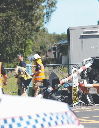  ??  ?? BIG MESS: Emergency services on scene after the collision between a car and the Kuranda tourist train at the Collins Ave crossing in Cairns North.