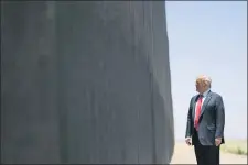  ?? EVAN VUCCI — THE ASSOCIATED PRESS FILE ?? In this June 23, 2020, file photo, President Donald Trump tours a section of the border wall in San Luis, Ariz. While Mexico never did pay for the “big, beautiful wall” Trump pledged to build along the southern border — the signature promise of his 2016 campaign — the project is now under way, with 450 miles expected to be completed by the end of December (only a fraction of that, however, has been built along stretches where no barrier stood before.)