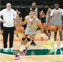  ?? LYNNE SLADKY/AP ?? Miami guard Matthew Cleveland works on drills as head coach Jim Larranaga, left, watches during practice on Oct. 23. Cleveland transferre­d from rival Florida State.