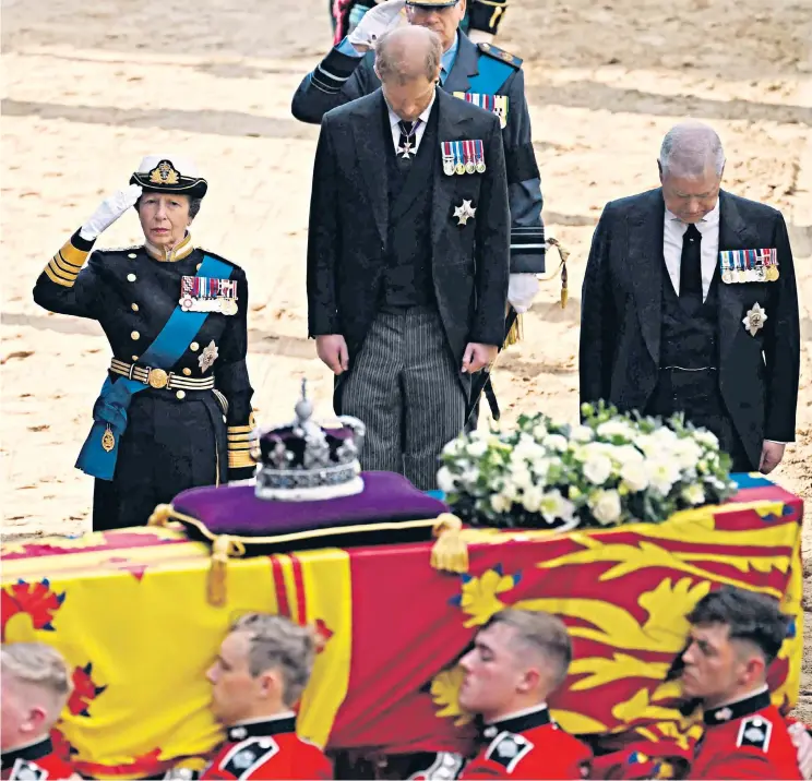  ?? ?? The King, the Princess Royal and the Prince of Wales salute Queen Elizabeth’s coffin, above. The Dukes of Sussex and York, who were not in military uniform, bowed instead. Left, the Princess of Wales being driven to the service in Westminste­r Hall. She wore a brooch given to her by the late Queen and a pair of earrings that once belonged to Diana, Princess of Wales. Right, the Duke and Duchess of Sussex walk behind the coffin into the hall