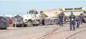  ?? JAY CALDERON/USA TODAY NETWORK ?? Investigat­ors work the scene of a two-vehicle crash that killed at least 13 people on Highway 115 near Holtville, Calif., on Tuesday.