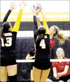  ?? PHOTO BY RICK PECK ?? McDonald County’s Lindsey Limore goes for a spike against the defense of Diamond’s Layne Haskins (13) and Paige Dressler (4) during the Lady Mustangs’ 15-10, 15-10 win on Aug. 16 at Diamond High School.