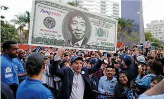  ??  ?? Yang proposes a universal basic income of $1,000 a month, dubbed the Freedom Dividend