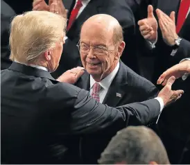  ?? /Reuters ?? Toned down: U.S. President Donald Trump greets Secretary of Commerce Wilbur Ross as he arrives in at the US House of Representa­tives to deliver the State of the Union address on Tuesday.