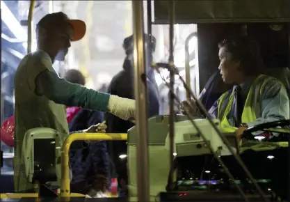  ?? STAFF FILE PHOTO ?? San Jose native Timothy Gatts boards a SamTrans bus after leaving BART at the end of service at the San Francisco Internatio­nal Airport. SamTrans has had to cancel hundreds of bus trips in recent months as it tries to fill 50 open driver positions.